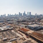 Aerial view of downtown Los Angeles with an active construction site, the kind of project that is screened against the 33 CEQA categorical exemptions