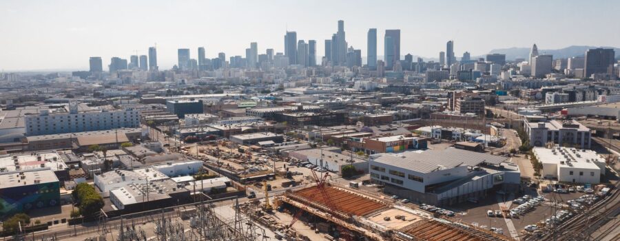 Aerial view of downtown Los Angeles with an active construction site, the kind of project that is screened against the 33 CEQA categorical exemptions
