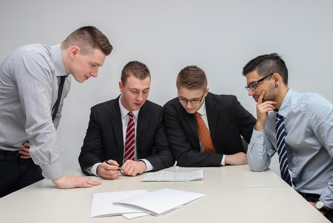 Project team reviewing entitlement application documents together at a table