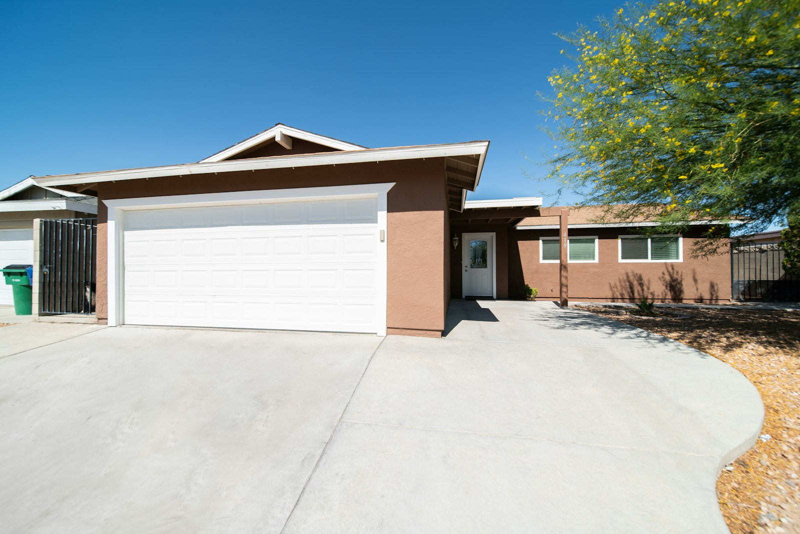 Two-car garage and concrete driveway at a single-family home, the type of space often converted into an ADU